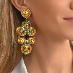 Gloria clip-on earrings in gold metallic resin and green crystals